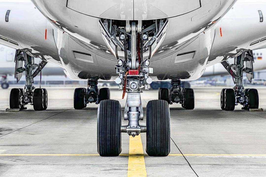 A passenger airplane parked on airport runway line