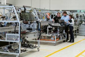 Engineers in a factory performing tests on electronic systems